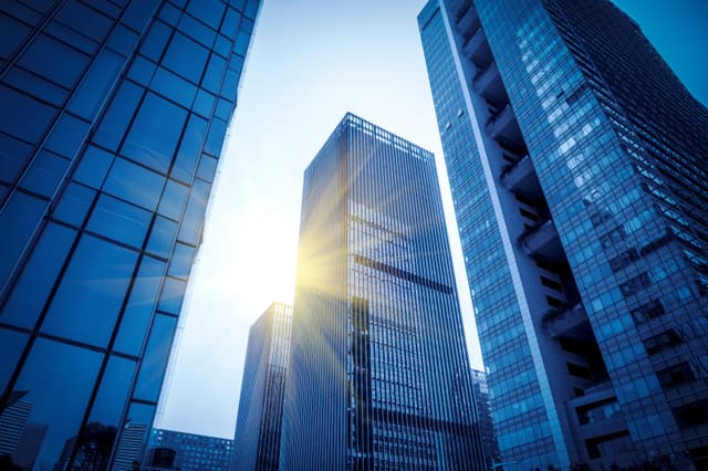 Glass office towers seen from below at dusk